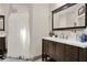 Well-lit bathroom featuring a wooden vanity with a large mirror and a shower with a curtain at 2150 Fincher Rd, Canton, GA 30114