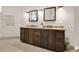 A bathroom with a granite countertop and two mirrors with a brown cabinet and tile floor at 2150 Fincher Rd, Canton, GA 30114