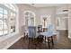 Cozy breakfast nook illuminated by large windows and featuring hardwood floors and seating for four around a glass table at 2150 Fincher Rd, Canton, GA 30114