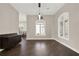 Charming dining area with a decorative window, hardwood floors, and modern pendant lighting at 2150 Fincher Rd, Canton, GA 30114