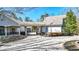 View of a stunning home featuring a spacious driveway leading to a covered portico and an American flag at 2150 Fincher Rd, Canton, GA 30114