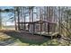 Exterior shot of a large, enclosed animal shelter with a roof and wooden platform base at 2150 Fincher Rd, Canton, GA 30114