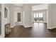 Spacious foyer with hardwood floors leads to the living areas and features an attractive console table at 2150 Fincher Rd, Canton, GA 30114