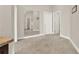 Spacious hallway with tan carpet and white trim with mirror and multiple doors at 2150 Fincher Rd, Canton, GA 30114