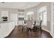 Bright kitchen featuring white cabinets, stainless steel appliances, and an adjacent breakfast nook with a round wooden table at 2150 Fincher Rd, Canton, GA 30114