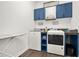 Well-organized laundry room with blue cabinetry and functional workspace at 2150 Fincher Rd, Canton, GA 30114