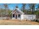 Charming outbuilding with a bell tower, surrounded by trees and grass at 2150 Fincher Rd, Canton, GA 30114