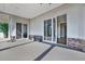 Rear patio featuring oversized glass sliding doors, recessed lighting, neutral stucco and stone facade at 2150 Fincher Rd, Canton, GA 30114