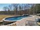 Stunning kidney shaped pool and spa with a stone surround and brick pavers at 2150 Fincher Rd, Canton, GA 30114