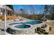 A luxurious pool and spa surrounded by stone and lush greenery at 2150 Fincher Rd, Canton, GA 30114