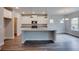 Kitchen displaying granite countertops, white cabinetry, stainless steel appliances, and hardwood floors at 3017 Abelia Dr, Buford, GA 30519