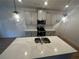 Close up on kitchen island featuring a stainless steel sink, quartz countertops and modern pendant lighting at 3037 Abelia Dr, Buford, GA 30519