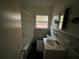 Bathroom features a tub, window, and a sink with storage underneath at 3195 Benjamin E Mays Sw Dr, Atlanta, GA 30311