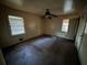 Bedroom featuring two windows for natural light, a ceiling fan, and carpeted flooring at 3195 Benjamin E Mays Sw Dr, Atlanta, GA 30311