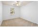 Bright bedroom with neutral carpet, a ceiling fan, and a window with natural light at 418 Lantern Wood Dr, Scottdale, GA 30079