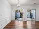 Dining area featuring updated lighting fixture, wood floors, and sliding door access to the exterior at 418 Lantern Wood Dr, Scottdale, GA 30079