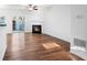 Bright living room featuring a fireplace, ceiling fan, wood floors, and a sliding door at 418 Lantern Wood Dr, Scottdale, GA 30079