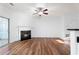 Bright living room with wood floors, fireplace, and sliding door access to the outside at 418 Lantern Wood Dr, Scottdale, GA 30079