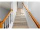 Stairs leading to upper level with white railings and carpet at 418 Lantern Wood Dr, Scottdale, GA 30079