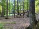 Wooded backyard featuring an elevated deck and peaceful scenery at 150 Melody Ln, Fayetteville, GA 30215