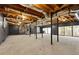 Unfinished basement with exposed ceiling, concrete floor and sliding glass doors at 150 Melody Ln, Fayetteville, GA 30215