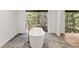 Beautiful bathroom with soaking tub and a picturesque view of the outdoors at 150 Melody Ln, Fayetteville, GA 30215