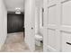 Powder room off hallway with black storage and modern lighting at 150 Melody Ln, Fayetteville, GA 30215