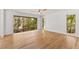 Bedroom with hardwood flooring and a large window overlooking the surrounding landscape at 150 Melody Ln, Fayetteville, GA 30215