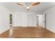 Bright bedroom boasts hardwood floors, neutral paint, ceiling fan, and closet with bi-fold doors at 150 Melody Ln, Fayetteville, GA 30215