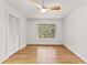 A modern bedroom with a wooden ceiling fan, hardwood floors, and a large window at 150 Melody Ln, Fayetteville, GA 30215
