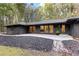 Charming one-story home featuring a modern design, large windows, and lush landscaping at 150 Melody Ln, Fayetteville, GA 30215