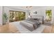 Staged main bedroom with hardwood flooring and plenty of natural light at 150 Melody Ln, Fayetteville, GA 30215