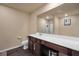 Clean main bathroom with large mirror, vanity with dark cabinets, and tile floors at 157 Oliver Dr, Locust Grove, GA 30248