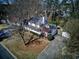 Aerial view of a lovely white house with mature trees and a long driveway at 1938 Kelvin Dr, Lawrenceville, GA 30043
