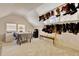 Spacious attic featuring a sloped ceiling, carpet flooring, and custom storage for multiple pairs of boots at 1938 Kelvin Dr, Lawrenceville, GA 30043