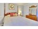 Bedroom with a four poster bed, a nightstand with a lamp, and a dresser with a mirror at 1938 Kelvin Dr, Lawrenceville, GA 30043