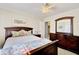 Inviting bedroom features a wooden bed frame with colorful floral bedding and a matching dresser at 1938 Kelvin Dr, Lawrenceville, GA 30043