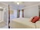 Neutral bedroom featuring a four poster bed, a patterned white coverlet, and plush pillows at 1938 Kelvin Dr, Lawrenceville, GA 30043