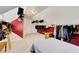 Unique closet with ample storage space, red accent walls, and clothing racks at 1938 Kelvin Dr, Lawrenceville, GA 30043