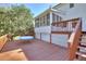 Exterior deck and screened in porch with staircase and wood railing at 1938 Kelvin Dr, Lawrenceville, GA 30043