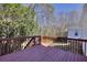 Exterior deck featuring wooden railing and an outdoor view of trees at 1938 Kelvin Drive Dr, Lawrenceville, GA 30043