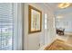 Bright entryway with a decorative mirror, hardwood floors, and a view of the dining area at 1938 Kelvin Dr, Lawrenceville, GA 30043