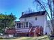 Two-story home with an exterior deck, screened in porch, and manicured lawn at 1938 Kelvin Dr, Lawrenceville, GA 30043