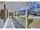 Inviting front porch featuring white columns, a railing, and views of the neighborhood street at 1938 Kelvin Dr, Lawrenceville, GA 30043