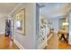 Spacious hallway with hardwood floors, staircase, and views of the living room at 1938 Kelvin Dr, Lawrenceville, GA 30043