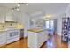 Open kitchen with white cabinetry, island, eat-in dining area, and modern appliances at 1938 Kelvin Dr, Lawrenceville, GA 30043