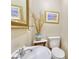 Cozy powder room features a decorative mirror and lovely accent pieces at 1938 Kelvin Dr, Lawrenceville, GA 30043