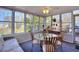 Bright sunroom with lots of windows, ceiling fan, carpet flooring, and dining table at 1938 Kelvin Dr, Lawrenceville, GA 30043