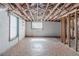 Unfinished basement featuring exposed ceiling beams, block walls, and natural light from a window at 238 Howell Sw Dr, Atlanta, GA 30331