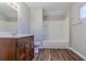 Cozy bathroom featuring a tub and shower combo, wood-look flooring, and a modern vanity at 238 Howell Sw Dr, Atlanta, GA 30331